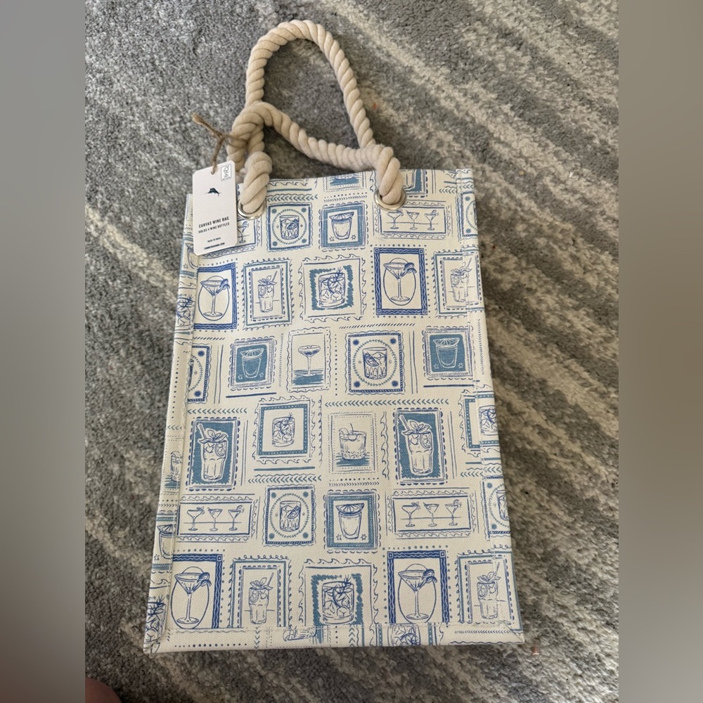 The item is a canvas wine bag by Tommy Bahama, designed to hold four bottles.